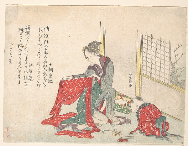 布をたたむ女