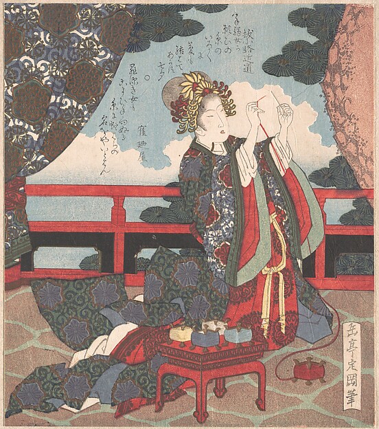 縁側で針に糸を通す女
