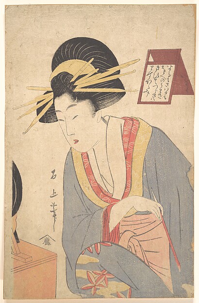 化粧する女